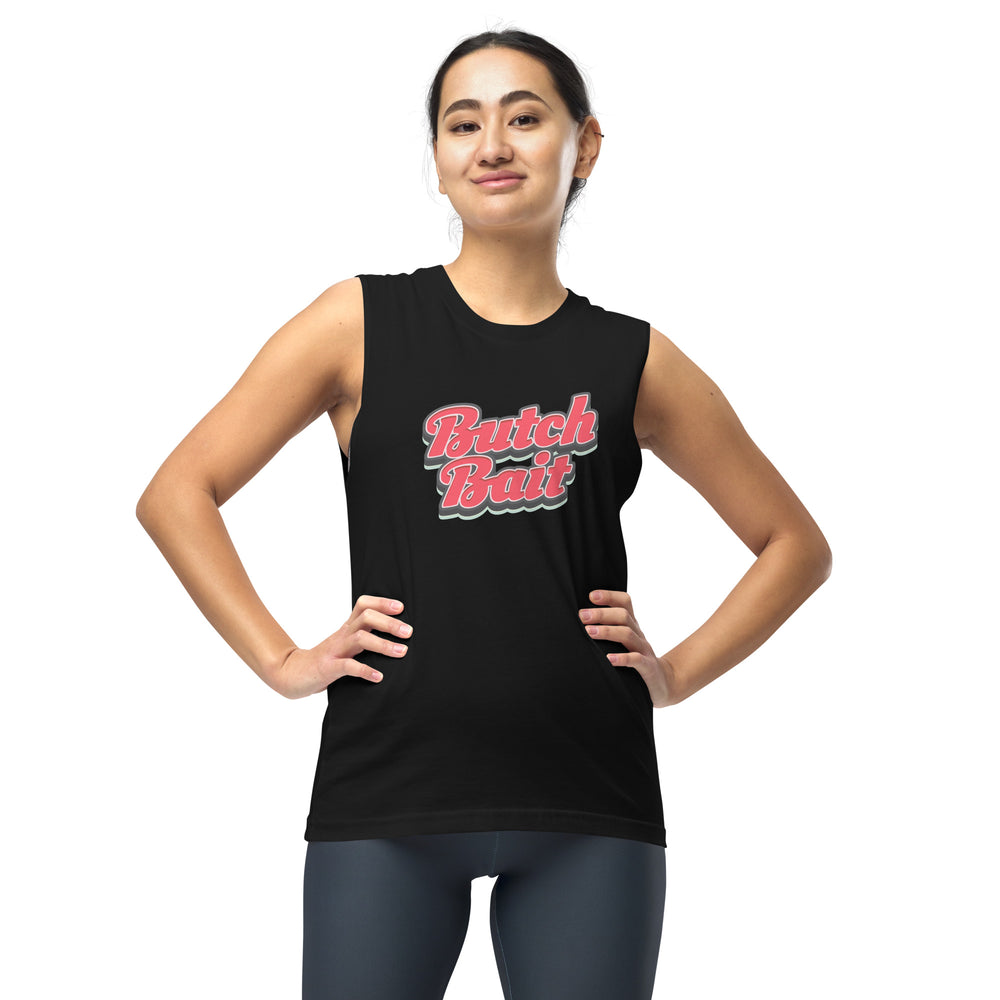 A dark haired woman with her hands on her hips, in front of a white background, in a black muscle shirt with the words Butch Bait in a stylised red text with a grey outline. Top by The Rainbow Stores