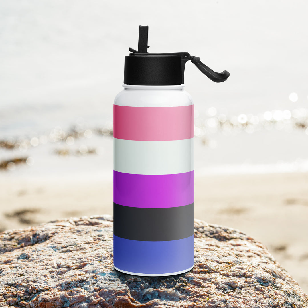 Stainless steel water bottle with a Gender Fluid Pride Flag printed around it, on a rock with a beach background. By The Rainbow Stores