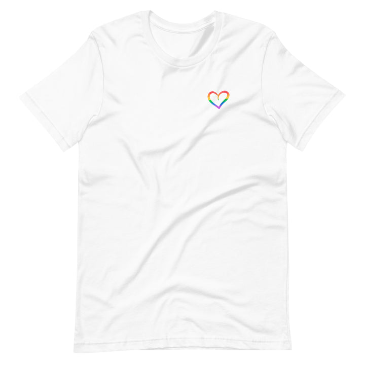 A white t-shirt on a white background, with a small hand drawn outline of a heart on the left side of the chest. Inside the lines of the heart are the stripes of a Rainbow Pride Flag.