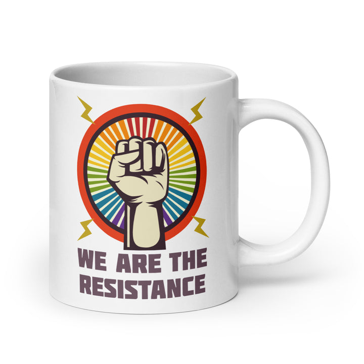 white ceramic mug with a circle and within it a clenched fist is surrounded by a rainbow starburst, and the words We Are The Resistance is below in black text. by the rainbow stores
